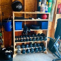 a garage with dumbs, exercise balls and other equipment in it's storage area