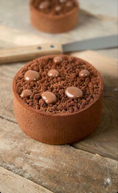 a chocolate cake sitting on top of a wooden table