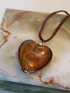 Beautiful brown glass in heart shape.  Embellished with yellow metal findings, and strung on a leather string.   Necklace measures a total of approximately 18 inches long including pendant.  Also has a 3 inch extender.  Pendant is approximately  1 1/4 inch long.   Condition Disclosure: Necklace in good condition with normal signs of age. All our items are vintage/antiques and most have had decades of use. A buyer of vintage objects should assume a baseline of wear. I am always honest and clear i Glass Heart Necklace, String Necklace, Vintage Objects, Glass Heart, Diamond Cluster Ring, Diamond Design, Diamond Cluster, Leather Chain, Silver Diamonds