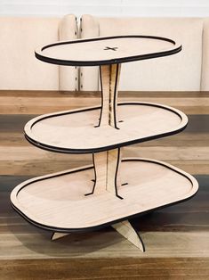 three tiered wooden table on top of a hard wood floor