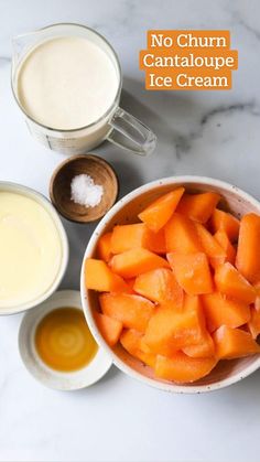 carrots, milk and other ingredients on a marble countertop with white bowls filled with orange juice