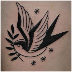 a black and white bird tattoo on the back of a woman's thigh, with stars in the background