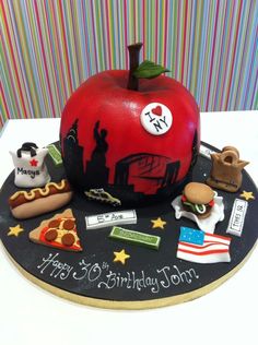 a birthday cake made to look like an apple on top of a black boarder