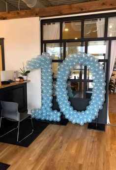 balloons are arranged in the shape of the letter o on display at an office party