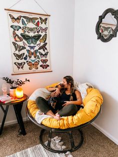 a woman sitting in a chair with her dog