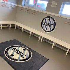 the interior of a soccer club with benches and lockers