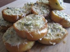 several pieces of bread with cheese and herbs on them