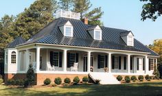 a large white house with black roof and windows