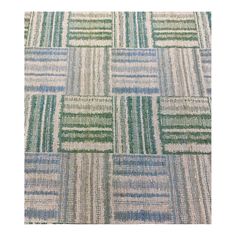 an upholstered rug with green and blue squares on the side, in various colors