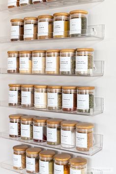 the spice rack is filled with many different kinds of spices