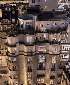 an aerial view of a building at night with lots of windows and balconies