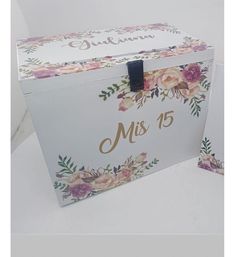 a white box with pink flowers and gold lettering on the lid that says mrs 15