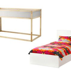 a bed with a colorful comforter next to a white desk