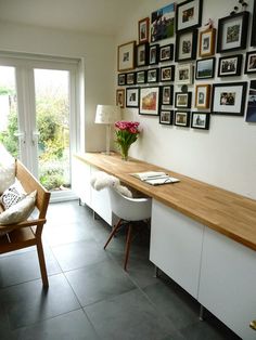 a living room filled with furniture and pictures on the wall