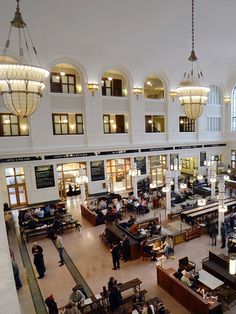 the interior of a large building with lots of people