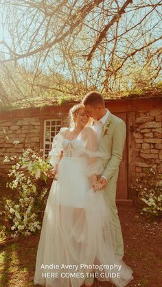 a bride and groom standing in front of a tree with the words here comes the guide