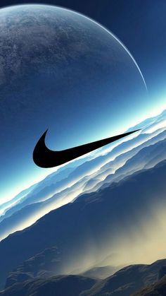 the nike logo is seen in front of an image of mountains and blue sky with clouds