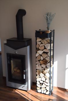 a stack of logs sitting next to an open fire place