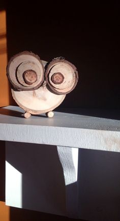 an owl figurine sitting on top of a shelf