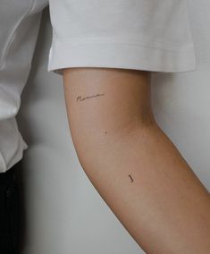 a woman's arm with a small tattoo on the left side of her arm