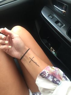 a woman's arm with the word hope tattooed on her left wrist in a car