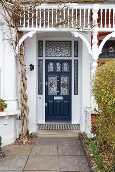 a blue front door on a white house