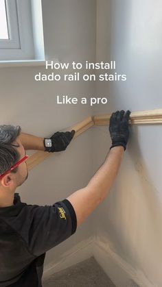 a man is painting the wall with white paint