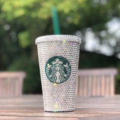 the starbucks cup is decorated with swarozak crystals