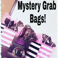 there is a pink and black bag that says mystery grab bags on the front, with chocolates in it