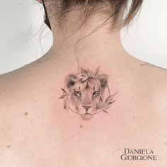 a woman with a lion tattoo on her back