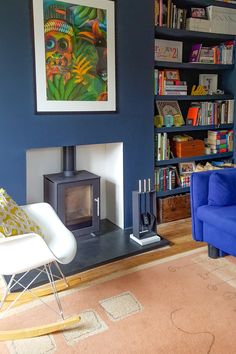 a living room filled with furniture and a fire place next to a bookshelf