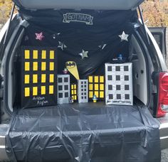 the back end of a vehicle with decorations on it's tailgate and trunk