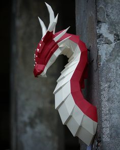 an origami dragon head mounted on the side of a building