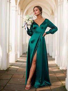 a woman in a long green dress holding a bouquet