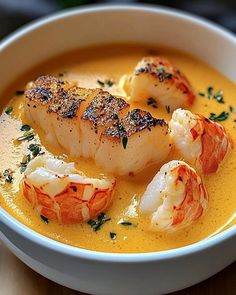 a white bowl filled with soup and shrimp