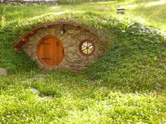 a hobbot house made out of rocks and grass