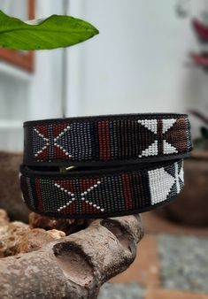 The Belts are made from ethically sourced leather in Kenya. The collars are then hand beaded by Maasai women artisans from my Village in Kajiado who have mastered the art. The hardware is made from 100% recycled brass. TO MEASURE CORRECTLY Our measurements are from the tip of the Buckle of the Collar to the second hole after the beaded section. General Belt SizeNumerical Belt SizeWaist Measurement (inches) XS 30 26.5-28 S 32 28.5-30 M 34 30.5-32 M 36 32.5-34 L 38 34.5-36 L 40 36.5-38 XL 42 38.5- Traditional Adjustable Brown Belt Buckles, Adjustable Brown Traditional Belt Buckles, Artisan Adjustable Fabric Belt, Traditional Black Adjustable Belts, Traditional Leather Belt Buckle, Adjustable, Adjustable Artisan Embroidered Belt, Adjustable Leather Belt Buckles In Traditional Style, Adjustable Traditional Leather Belt Buckles, Adjustable Leather Belt Buckles, Traditional Style