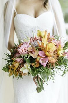 a bride holding a bouquet of flowers in her hands