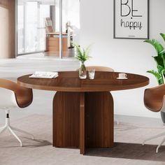 a table with two chairs around it and a plant in the corner on the other side