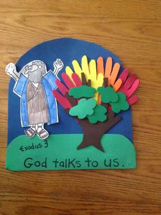 a child's paper cutout of a tree with the words god talks to us