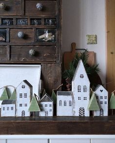 several small houses are sitting on a mantle