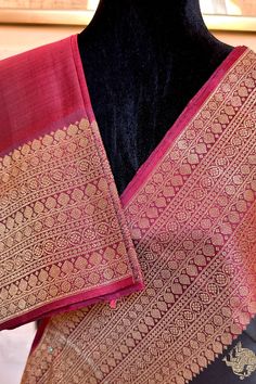 This banarasi inspired stunning kanjivaram saree in kanchana black is handwoven with traditional motifs in gold zari on the body. The borders in deep maroon have traditional motifs like floral, chakras and geometric patterns in gold zari. The grand pallu in deep maroon color mirrors the patterns of the borders in gold zari. Approximate Length 6.5 mtrs (inclusive of blouse length) Approximate weight - 1.5 lbs Approximate Height - 48 - 52" Saree comes with fall, picot and tassels done when applicable. Blouse piece is cut. Kindly Note : The colors you see on your device may vary due to the color reproduction, brightness and resolution of individual devices. If you'd like more clarity before your purchase, please contact our support team. Black Art Silk Pre-draped Saree With Zari Weaving, Traditional Black Pre-draped Saree, Traditional Festive Pre-draped Saree With Border, Black Pre-draped Saree With Traditional Patterns, Black Bollywood Handloom Pre-draped Saree, Black Silk Handloom Pre-draped Saree, Black Handloom Pre-draped Saree For Festivals, Traditional Pre-draped Saree With Woven Motifs For Diwali, Black Pre-draped Saree With Zari Weaving For Puja