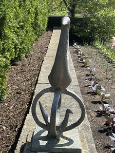 a stone sculpture in the middle of a garden