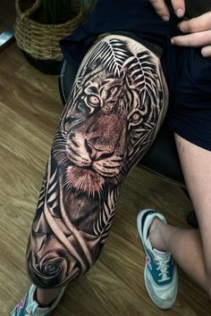 a person with a tiger tattoo on their leg