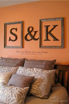 there are two framed letters above the bed