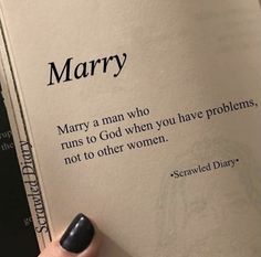 a person holding an open book with the words marry written on it, in black and white