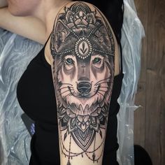 a woman with a wolf tattoo on her arm