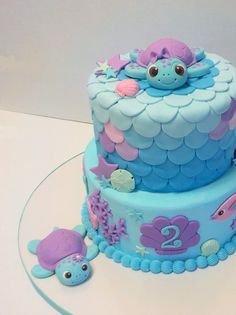 a blue and purple cake with sea animals on it