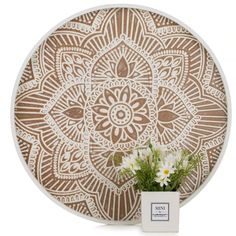 a vase filled with flowers sitting on top of a wooden wall art piece in front of a white background