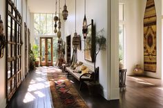 a hallway with lots of hanging lights and rugs